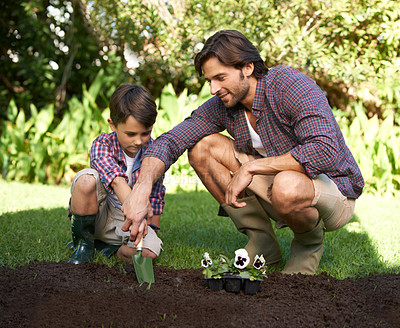 Buy stock photo Child, father and support with gardening and flowers in nature for agriculture growth and ecology education. Soil, compost and a man teaching boy kid to plant with spade for organic earth harvest