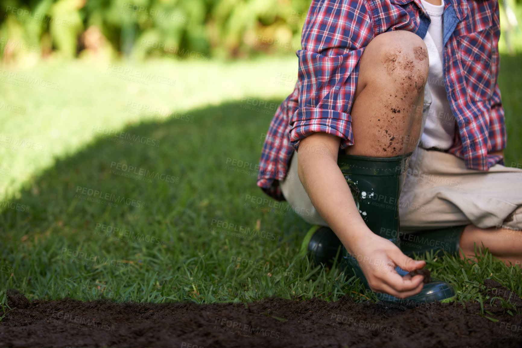 Buy stock photo Legs, hands and child gardening with soil in nature for ecology and development education. Kid, dirt and planting in yard and playing in backyard for environmental landscaping in summer leisure