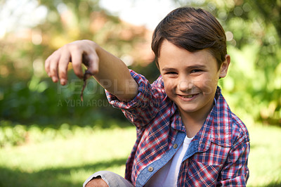Buy stock photo Boy, smile and portrait holding a worm in a garden for fun learning, development and growth. Curious, happy and young male person with a bug animal in nature for ecology education in environment