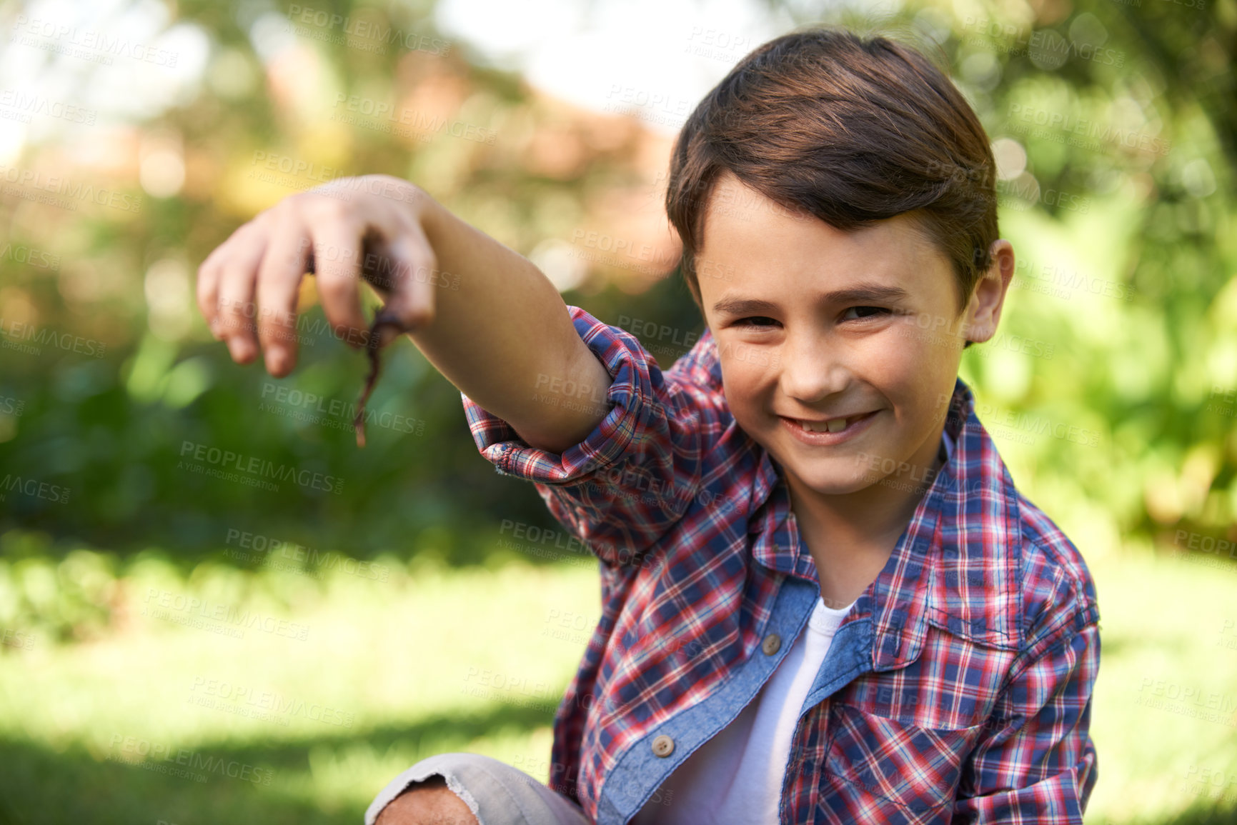 Buy stock photo Boy, smile and portrait holding a worm in a garden for fun learning, development and growth. Curious, happy and young male person with a bug animal in nature for ecology education in environment