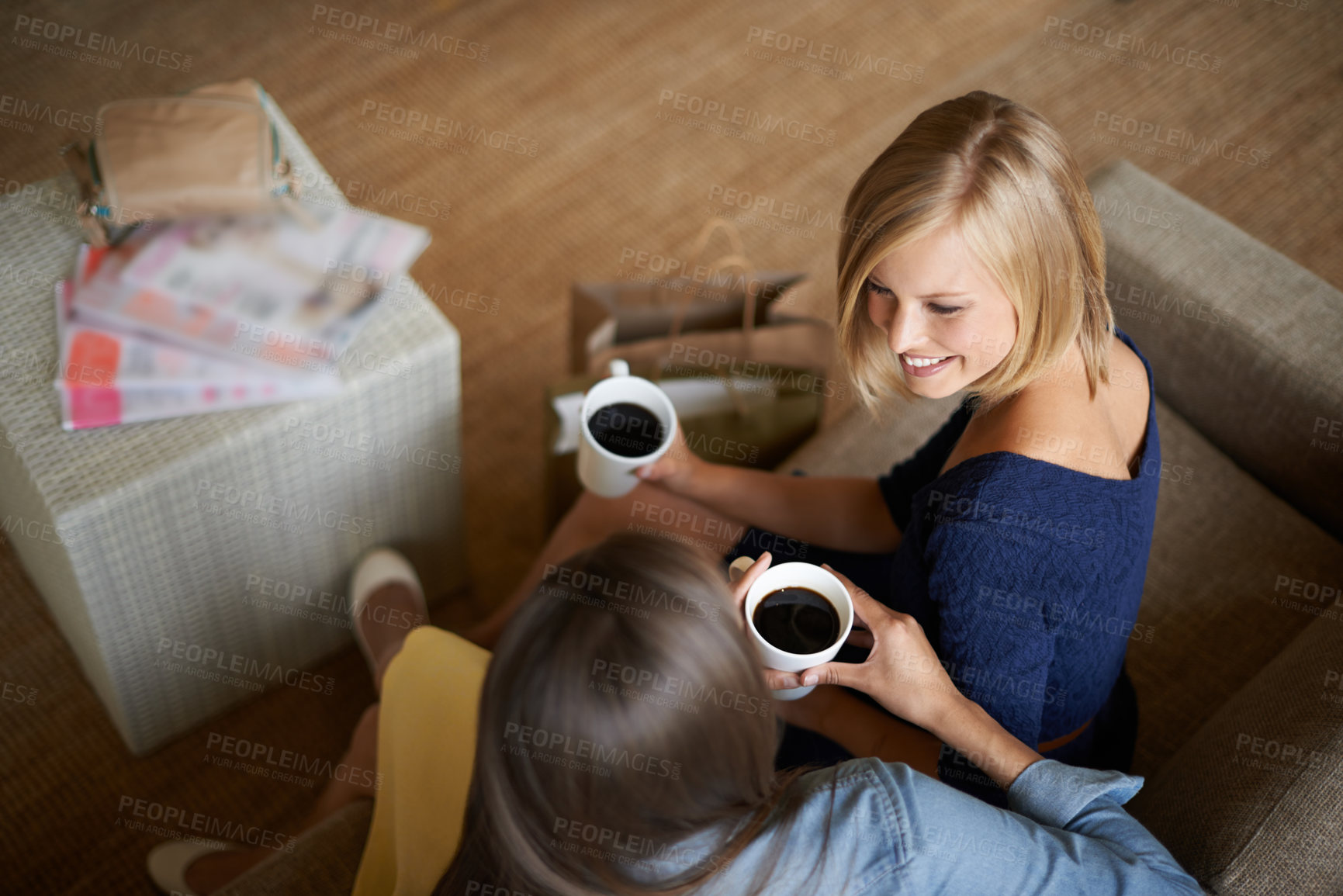 Buy stock photo Friends, women and drinking coffee from above to relax on the sofa at home. Female people, smiling and bonding with care to rest with tea drinks and conversation after retail shopping