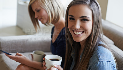 Buy stock photo Portrait, friends and drinking coffee while relaxing on the couch with a phone for social media. Face, women and smiling on sofa in the living room for smartphone meme or media online and bonding