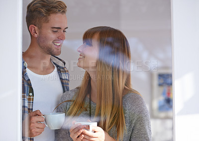 Buy stock photo Couple, morning and drinking coffee by window and love on weekend, romance and hot tea at home. Happy people, bonding and peaceful or relaxation, commitment and loyalty to marriage or relationship 