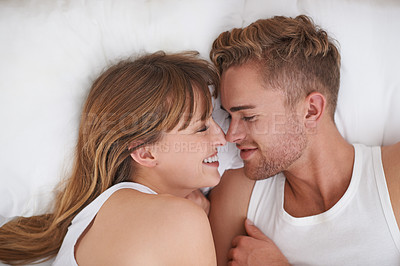 Buy stock photo Couple, love and relaxing in bed on weekend, happy and bonding or care in relationship at home. People, loyalty and commitment to marriage in bedroom, smiling and romance or comfortable and lazy