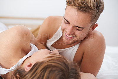 Buy stock photo Couple, love and lying in bed with happiness and care for  conversation with partner. Husband, smile and connection with wife on communication and discussion for marriage in bedroom and house  