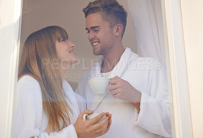 Buy stock photo Couple, morning and drinking coffee by window and relaxing on weekend, romance and hot tea at home. Happy people, bonding and peaceful or cozy, commitment and loyalty to marriage or relationship