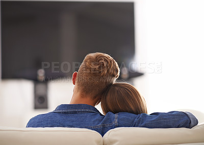 Buy stock photo Couple, together and hug watching TV, home and relaxing for break, couch or sofa while bonding. Partners, streaming and enjoyment of subscription, relax and embrace in lounge for romance and love