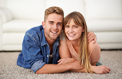 Buy stock photo Happy, portrait and couple lay on carpet of living room in house to relax, bonding and romance for love. Man, woman and together on rug in lounge of home with affection, care and hug for connection
