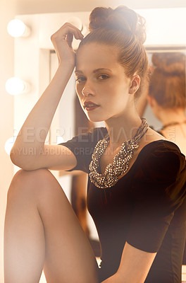 Buy stock photo Cropped shot of a young woman leaning on her knee in a make up room