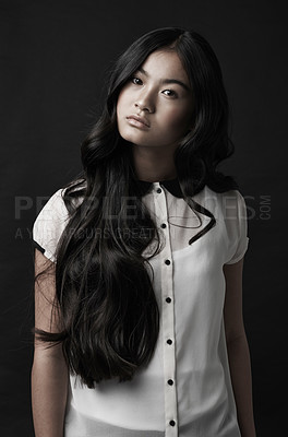 Buy stock photo Studio shot of a beautiful young woman posing against a black background