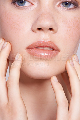 Buy stock photo Cropped close up of a young woman touching her face