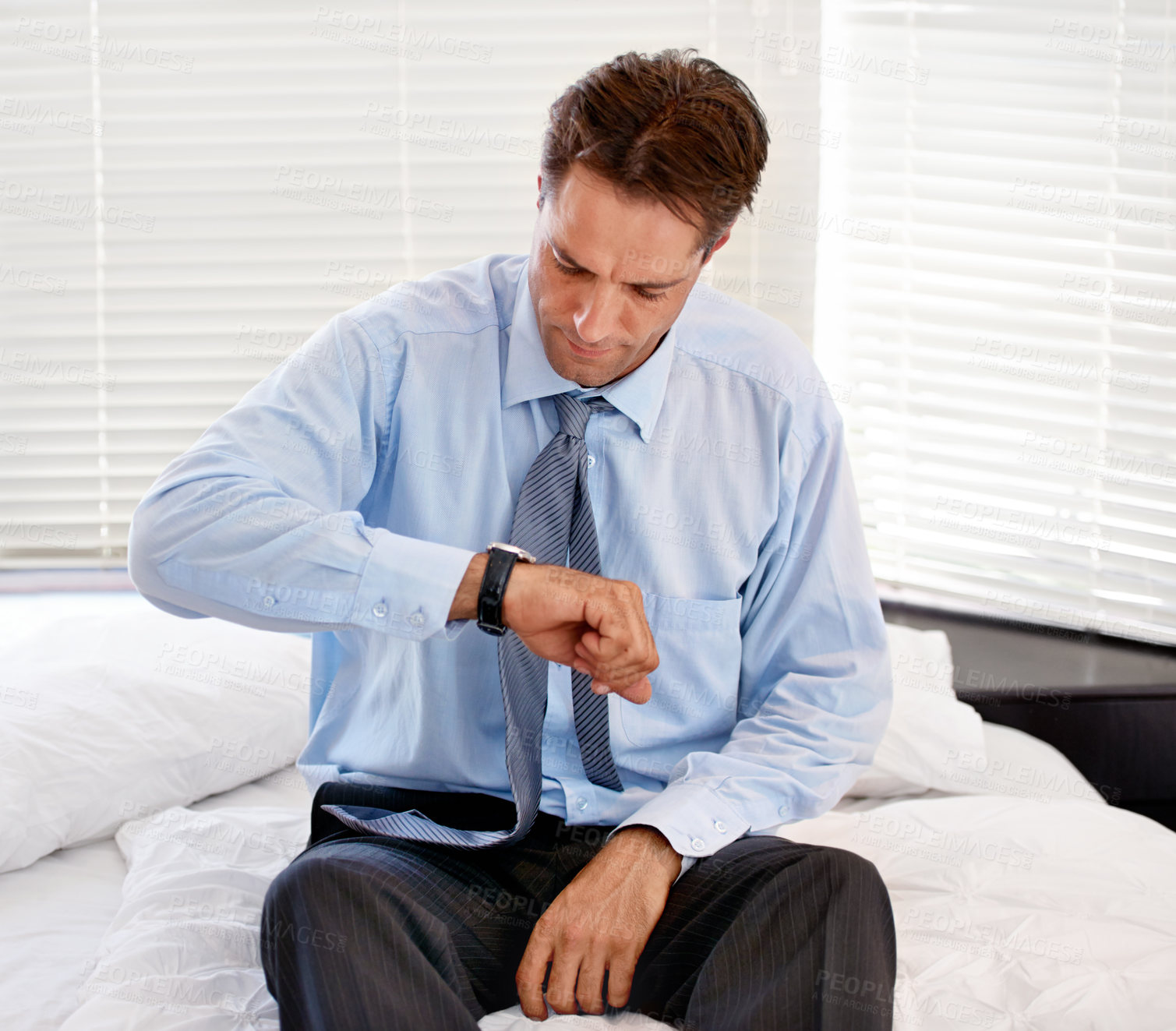 Buy stock photo Businessman, late and watch in bed, home and stressed by time, unhappy and anxiety for schedule of job. Auditor, sad and bedroom in house, morning and frustrated with oversleep for work by insomnia