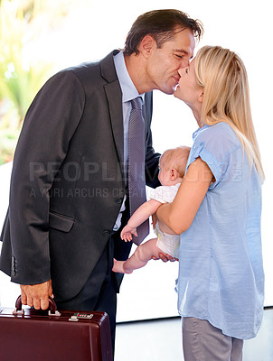 Buy stock photo Businessman, family and parents kiss baby, love in relationship or welcome home on valentines day. Kid, toddler and mother with father in romance for connection, greeting or arrival together in house