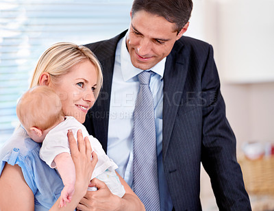 Buy stock photo Home, businessman and mother smile with baby in morning as family, couple and parents together. House, man and woman with child in kitchen with happiness for growth and development of infant