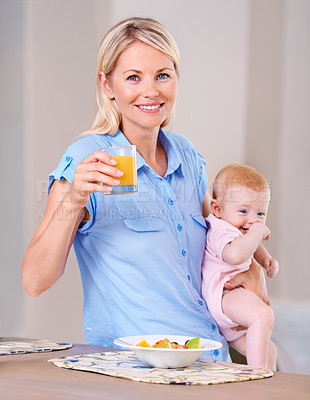 Buy stock photo Woman, baby and happy with house, portrait and breakfast with fruit, orange juice and smile. Mother, daughter and food for health, wellness and home with morning, girl and kitchen for rest or eating 