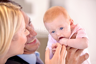 Buy stock photo Closeup, parents and child with smile, happy and love in a house kitchen and holding infant. Mom and dad with baby, home and touch for relationship, family and bonding with father, mother and girl