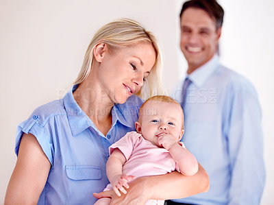 Buy stock photo Baby, happy and cute with mom as family in a home and dad smile for child with love and marriage. Man, relax and together with woman as parents to a kid with care and happiness or trust of mother  