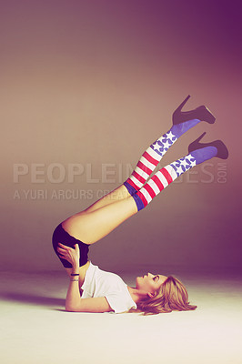 Buy stock photo Woman, usa fashion and socks of a model with flag legs and heels in air in studio. Isolated, young female person and gen z clothes with youth and carefree feeling relax with patriotic aesthetic