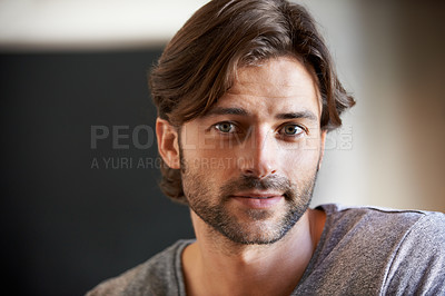 Buy stock photo Shot of a young man sitting at home