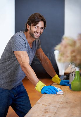 Buy stock photo Happy man, portrait and cleaning table for housekeeping, hygiene or disinfection on furniture or surface at home. Male person, maid or cleaner and gloves for wiping, bacteria or germ removal at house