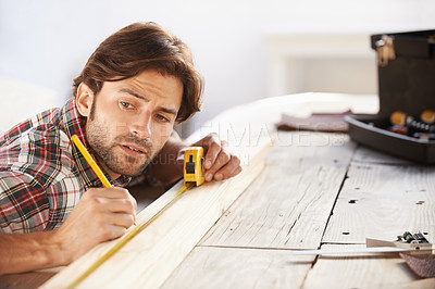 Buy stock photo Carpenter, wood and measuring tape with man for DIY or renovation in a workshop. Craftsman, timber or measure with object for scale with construction and male person contractor with woodwork