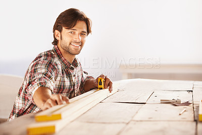 Buy stock photo Carpenter, measuring tape and wood in workshop, smile and happiness for  job, service and plan. Man, working and builder for furniture, professional and machine for craft, career and industry