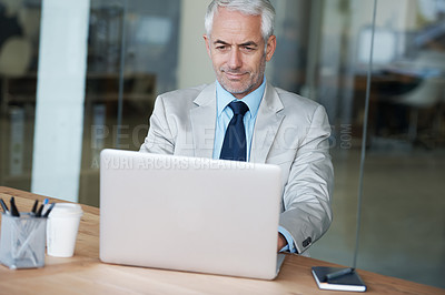 Buy stock photo A manager working on his laptop in the office