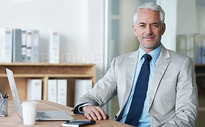 Buy stock photo A manager sitting at his desk and smiling at the camera