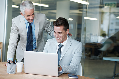Buy stock photo Senior businessman, employee and laptop for training, leadership and mentor on technology. Businesspeople, consulting and advice or feedback on report, proposal and discussion or teaching in office