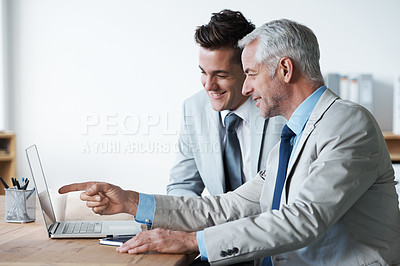 Buy stock photo Two corporate businessmen looking at a laptop