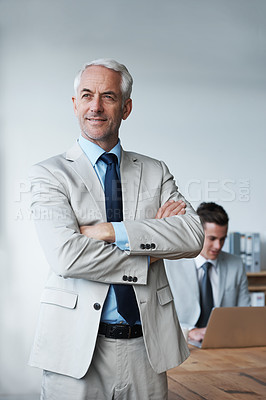 Buy stock photo Senior businessman, professional and confidence in leadership, agency and pride for mentoring in office. Male person, arms crossed and smile for support in management, advisor and laptop for planning