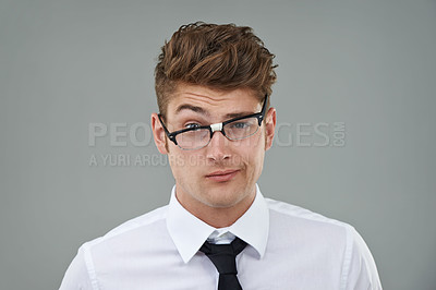 Buy stock photo Businessman, glasses and funny portrait in studio for optical healthcare, comedy and humor on gray backdrop. Male person, eyewear and joking with frame choice, optometry and lens for vision support