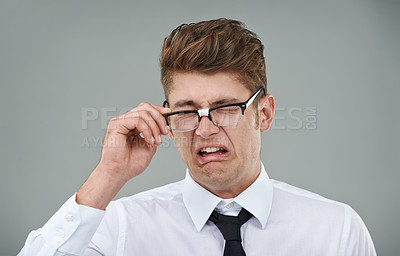 Buy stock photo Businessman, glasses and disgust in studio for optical healthcare, omg and overwhelmed on gray backdrop. Male person, eyewear and dislike the frame choice, optometry and lens for vision support