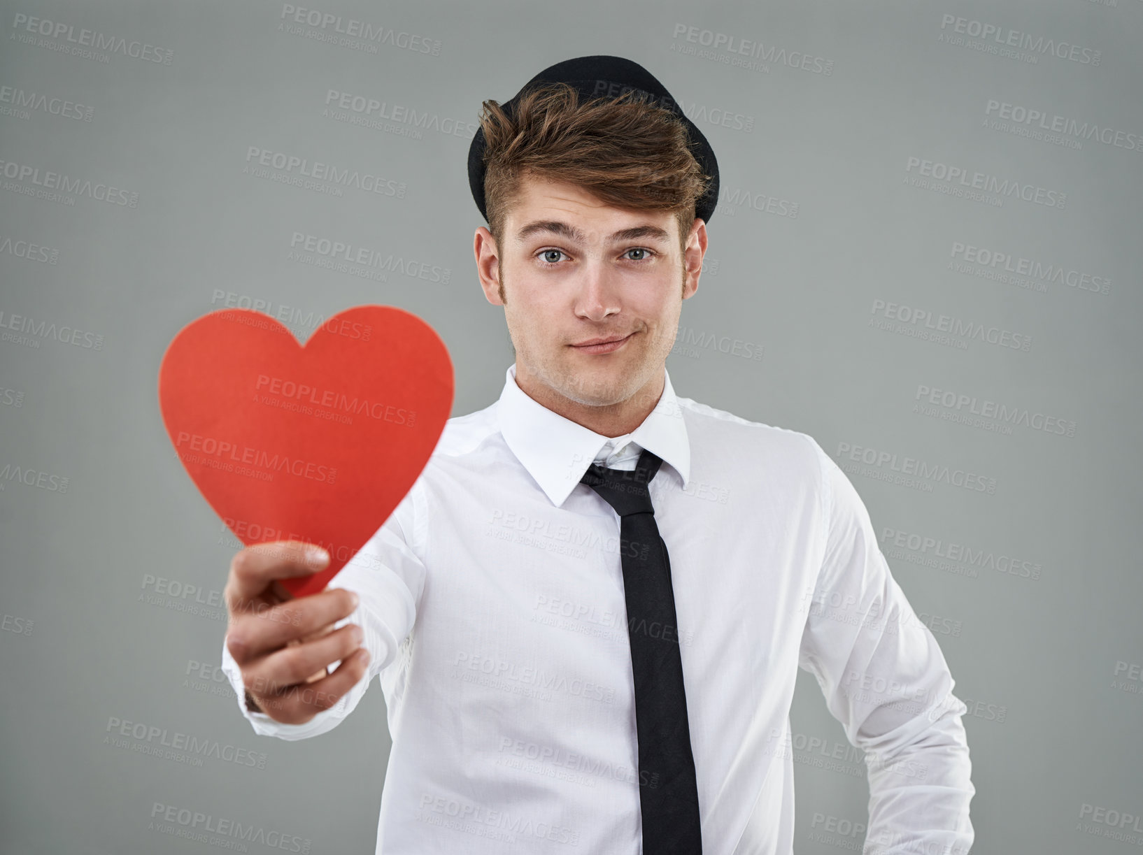 Buy stock photo Portrait, man and heart in studio holding greeting card for Valentines day, romantic and mockup. Hopeful, trendy guy and gen z hipster with shirt, tie and smile against light grey background