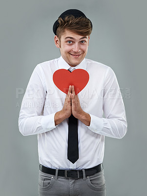 Buy stock photo Portrait of a handsome young man holding a cardboard heart