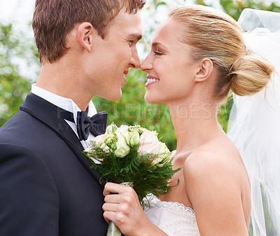 Buy stock photo Couple, happy and love for wedding celebration in outdoors, together and smiling in nature. People, nose touch and commitment to relationship with marriage, bouquet and romance at outside ceremony