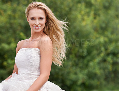 Buy stock photo A gorgeous young bride smiling and looking stunning in her wedding dress alongside copyspace