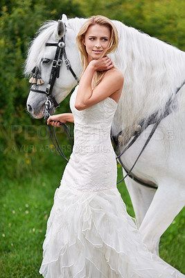 Buy stock photo An attractive young bride outside with her horse