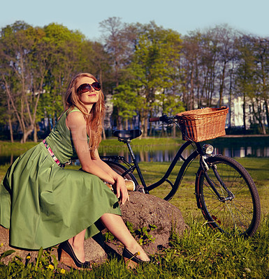 Buy stock photo Happy, smile and bicycle with woman in park for cycling, freedom and nature. Spring, relax and peace with female person and bike resting on rock in grass field for health, summer break and happiness