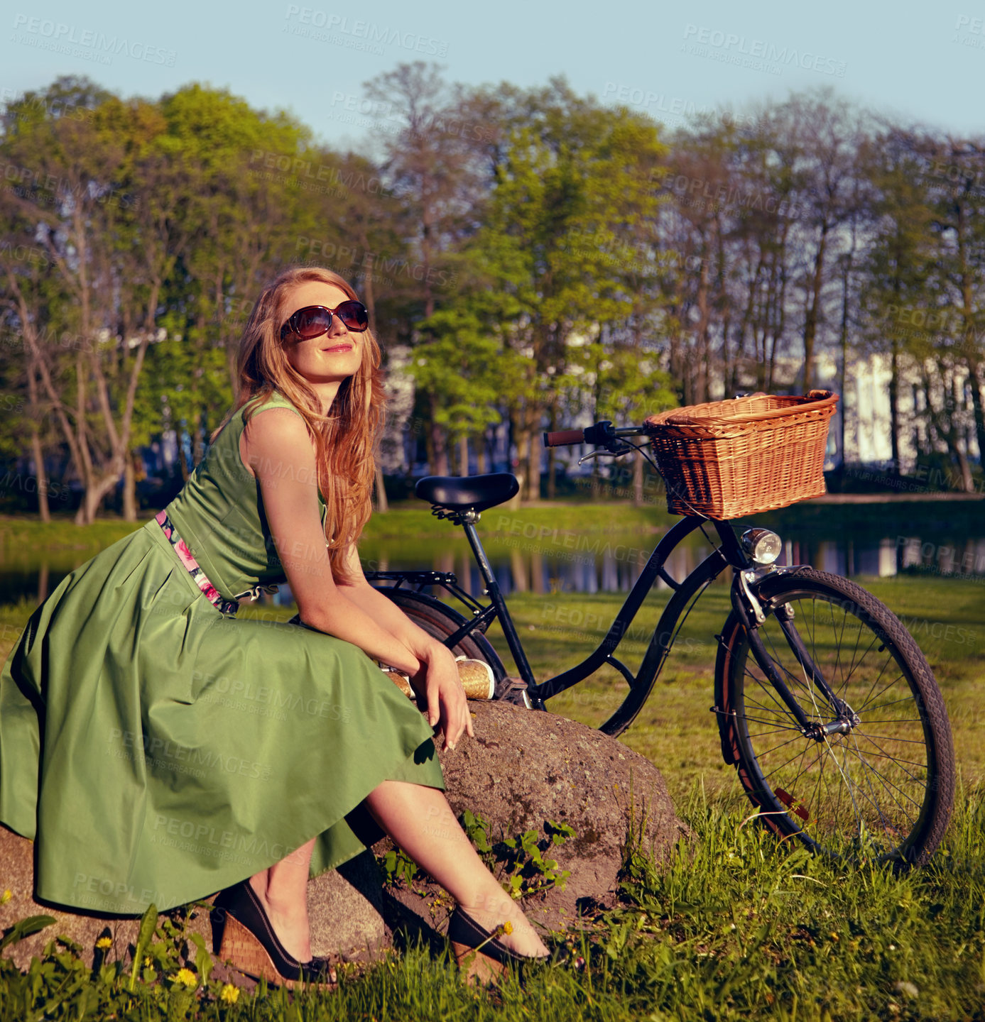 Buy stock photo Happy, smile and bicycle with woman in park for cycling, freedom and nature. Spring, relax and peace with female person and bike resting on rock in grass field for health, summer break and happiness