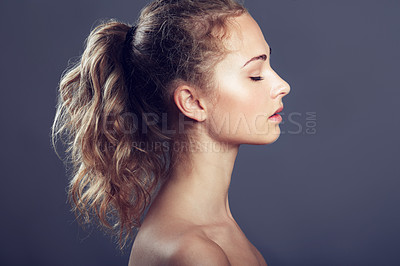 Buy stock photo An attractive young woman with her eyes closed in studio