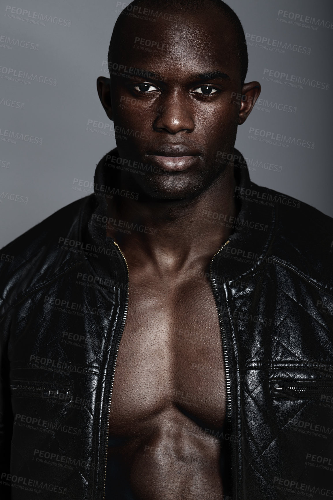 Buy stock photo Fashion, portrait and black man in leather jacket in studio isolated on a gray background. African male model, serious face and coat, confidence and stylish clothes or trendy outfit from Nigeria.
