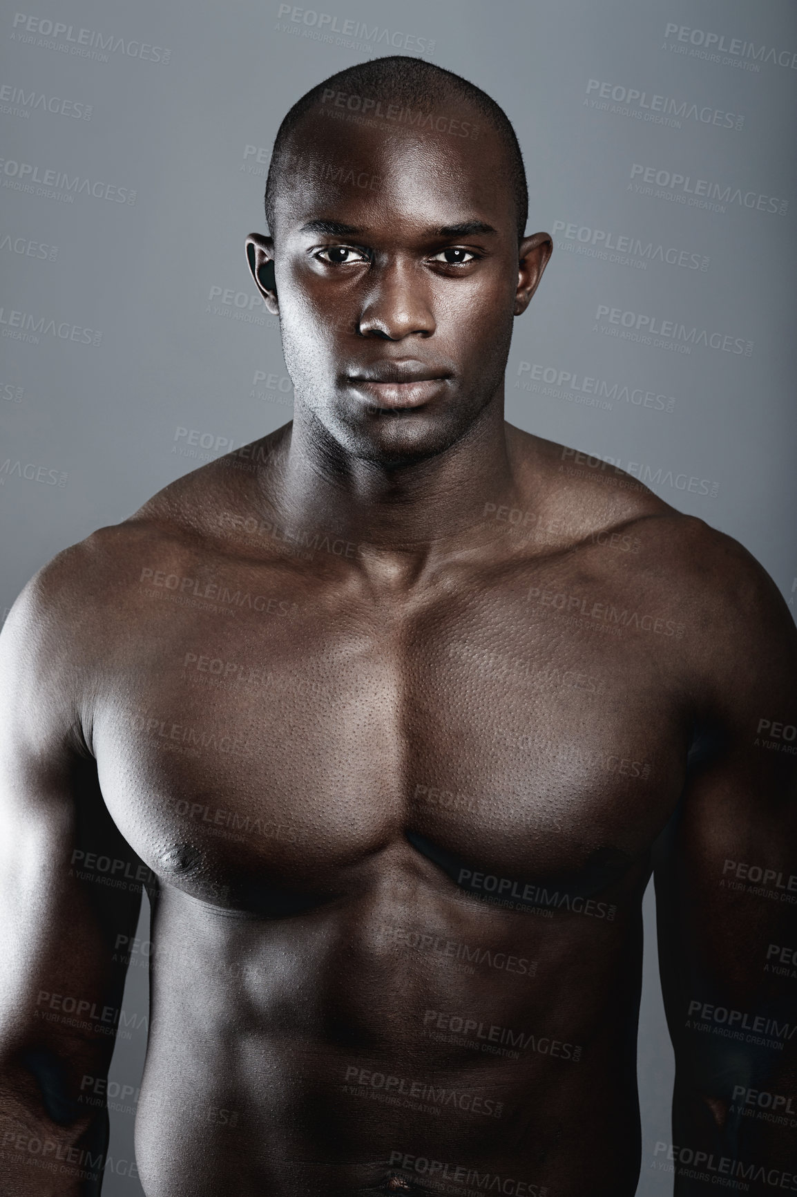 Buy stock photo A handsome and muscular young man posing in the studio