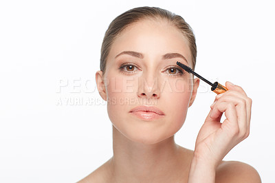 Buy stock photo Beautiful woman putting on mascara