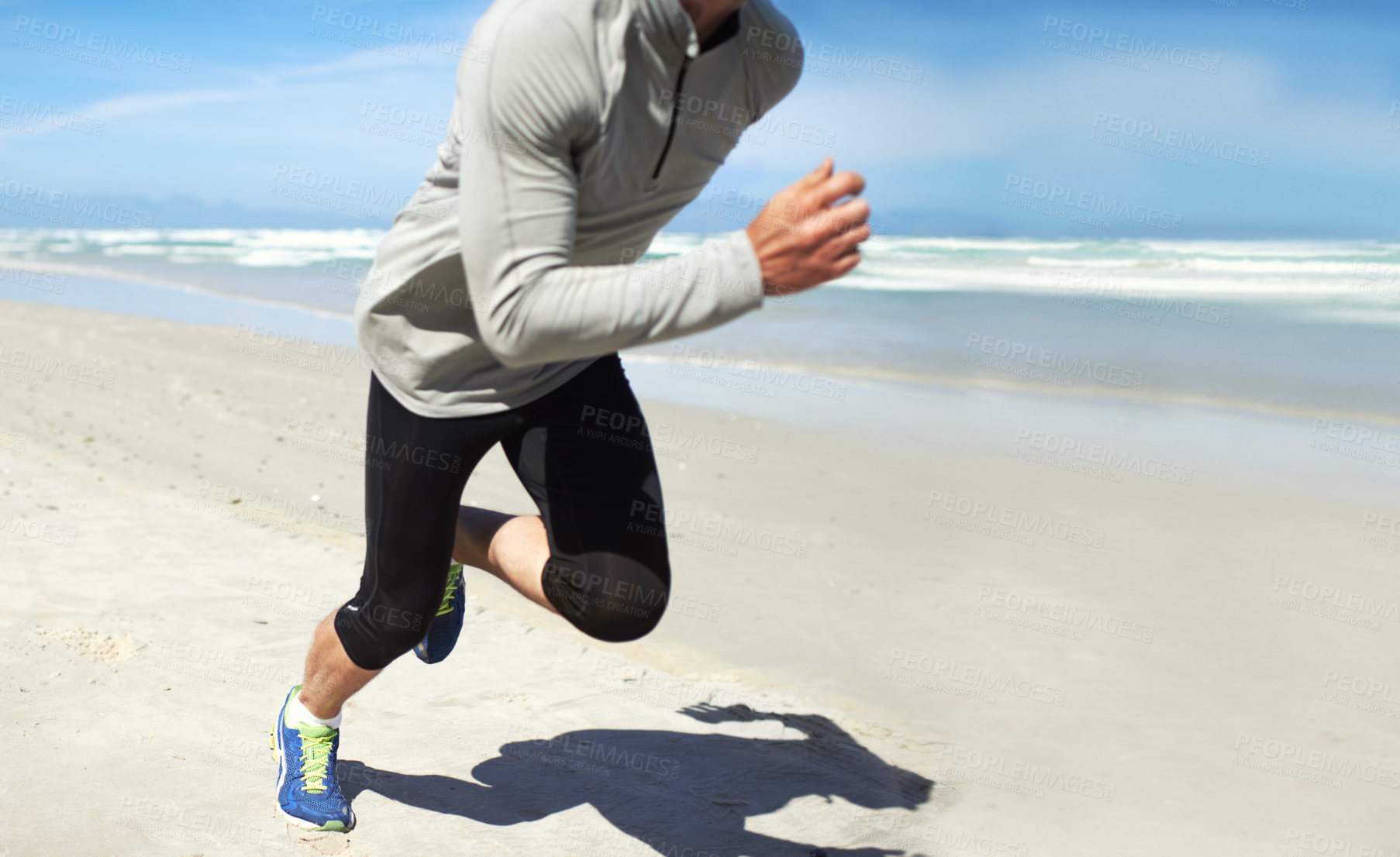 Buy stock photo Cropped shot of a man running along the beach