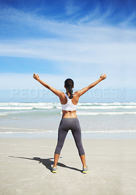 Buy stock photo A young jogger standing on the beach