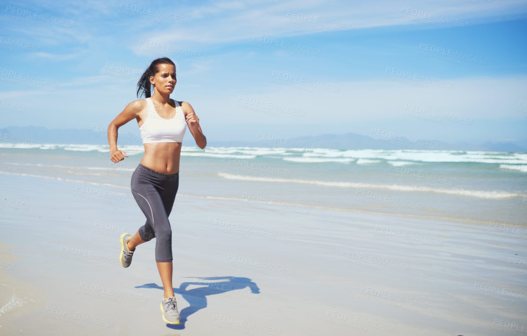 Buy stock photo Fitness, space or Indian woman at sea running for exercise, training or outdoor workout at beach. Sports person, runner or healthy female athlete on sand for cardio endurance, wellness or mockup 