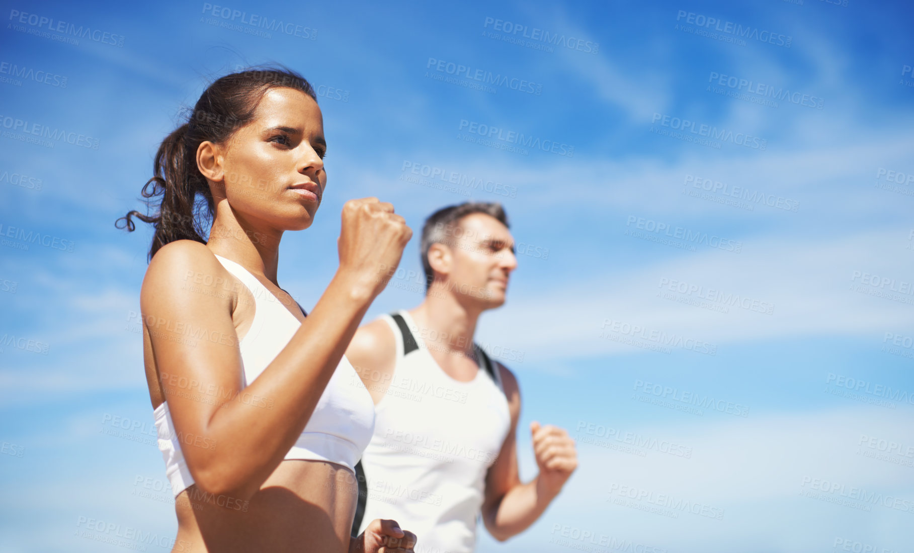 Buy stock photo Shot of two people running outdoors