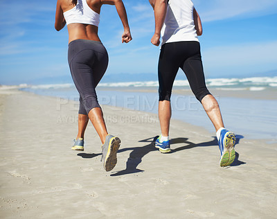 Buy stock photo A couple running at the beach