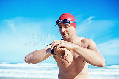Buy stock photo Sea, swimming and time of a man with a watch for heart rate, wellness and fitness app for sport. Beach, athlete and ocean with clock and timer for marathon or race training in summer outdoor